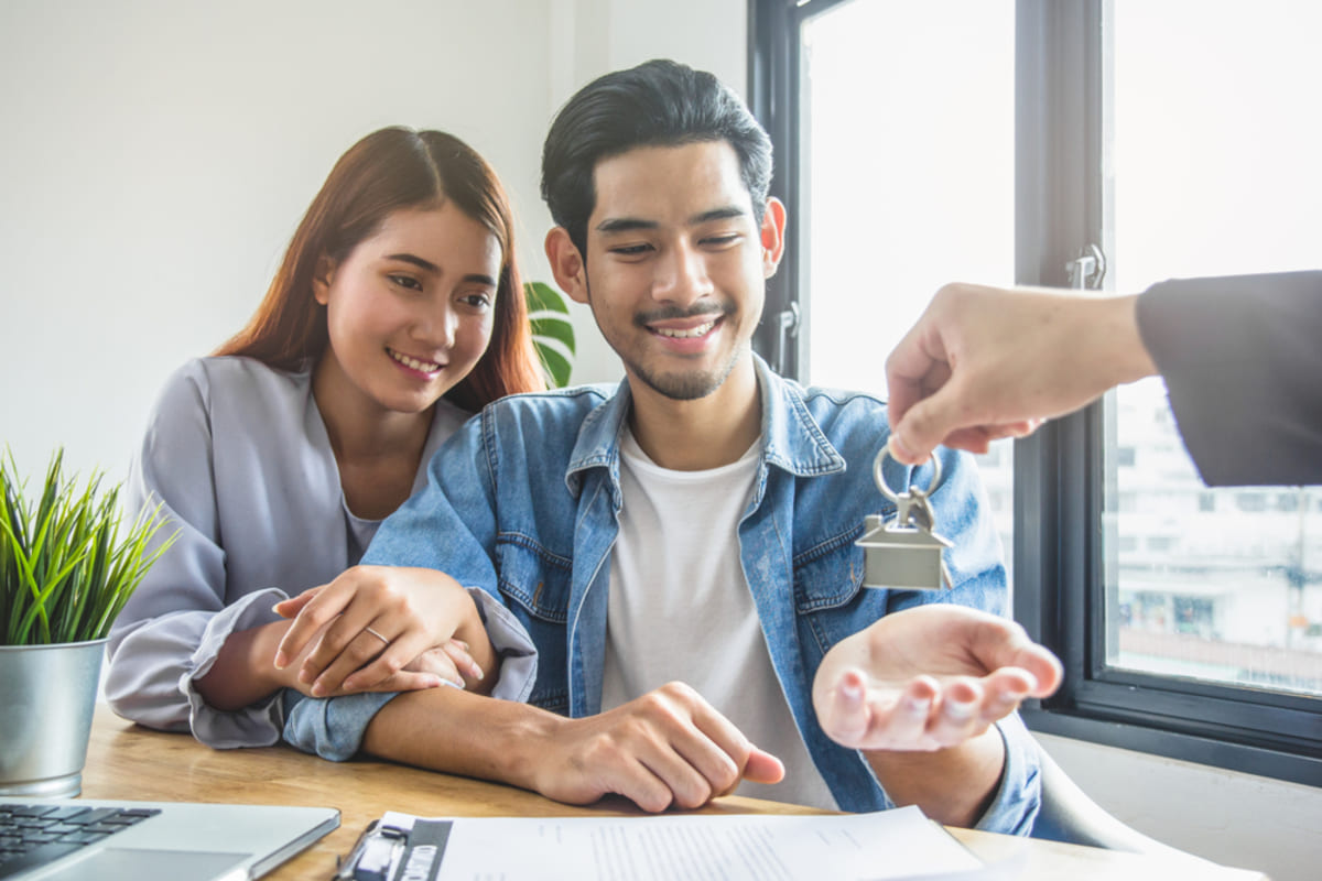 A couple receiving house keys, Osprey Property Management concept