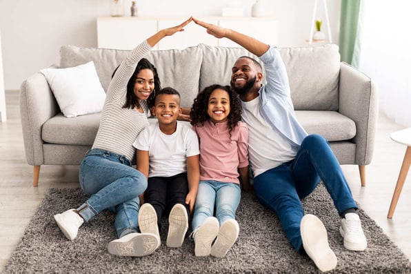  A family on the floor in a living room, Rhino security deposit insurance protection concept