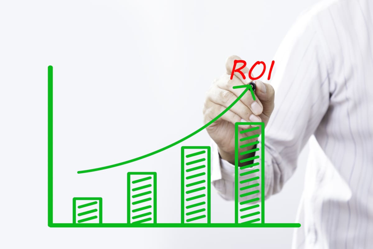A green chart with an arrow pointing up, rental property ROI concept