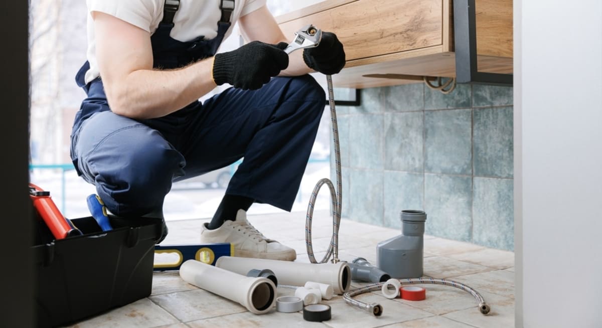 A plumber repairing a sink