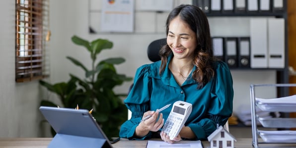 A property manager holding a calculator