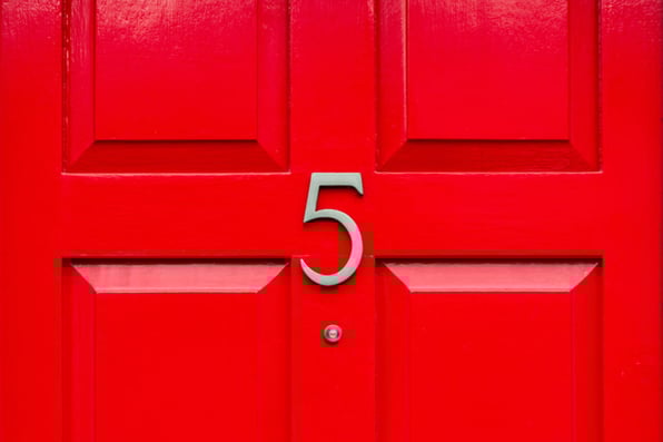 A red door with the number 