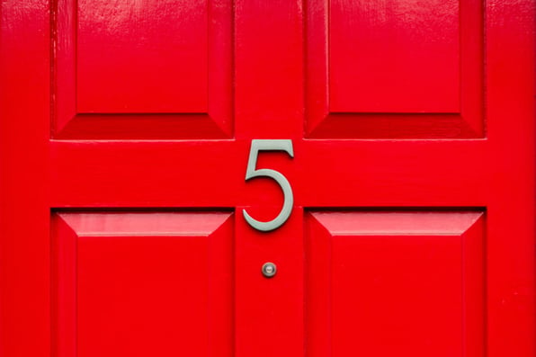 A red door with the number 