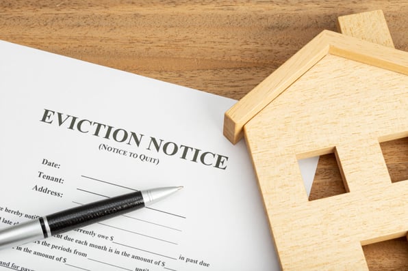 An eviction notice next to a model house, how to handle an eviction concept