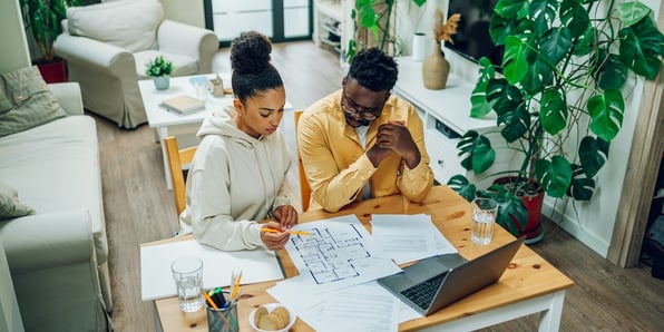Couple reviewing blueprints of a rental property
