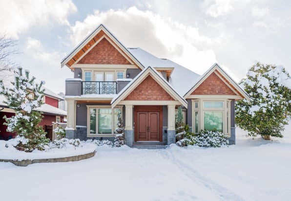 Front image of a house covered in snow