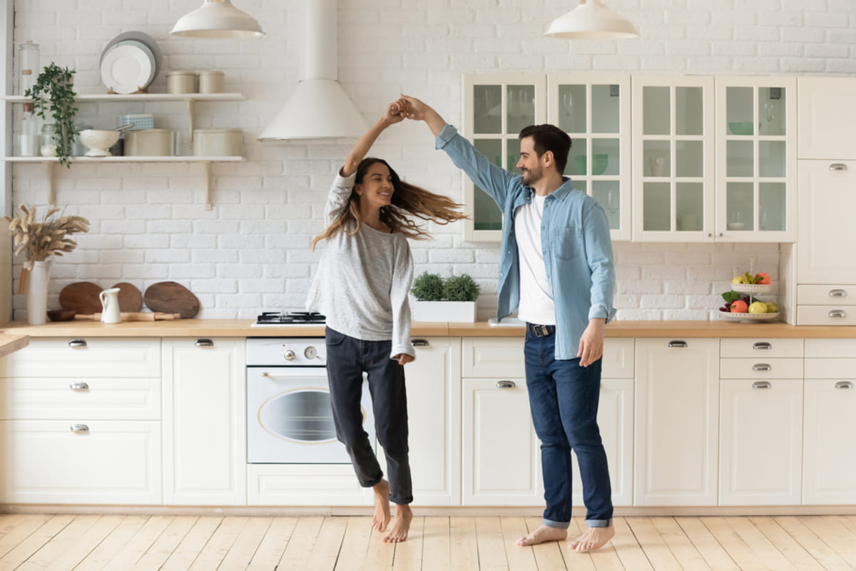 Happy tenants dancing in their kitchen