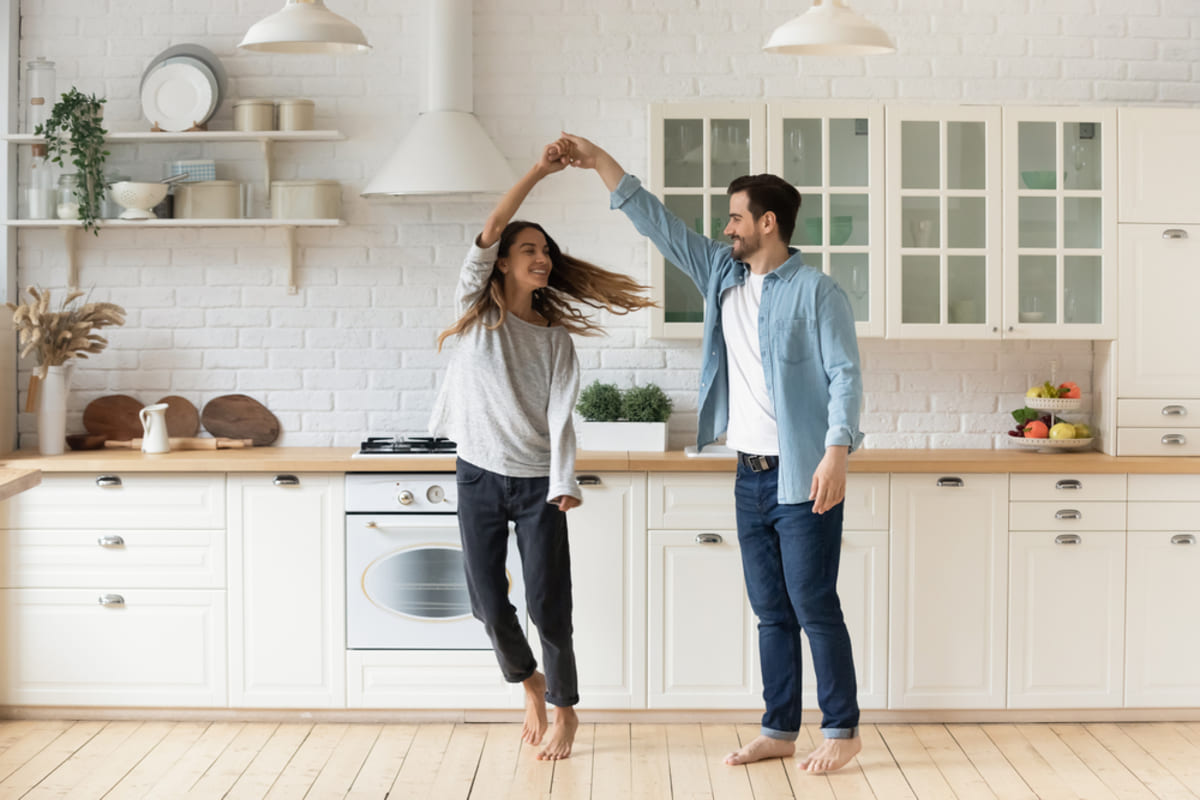 Happy tenants dancing in their kitchen