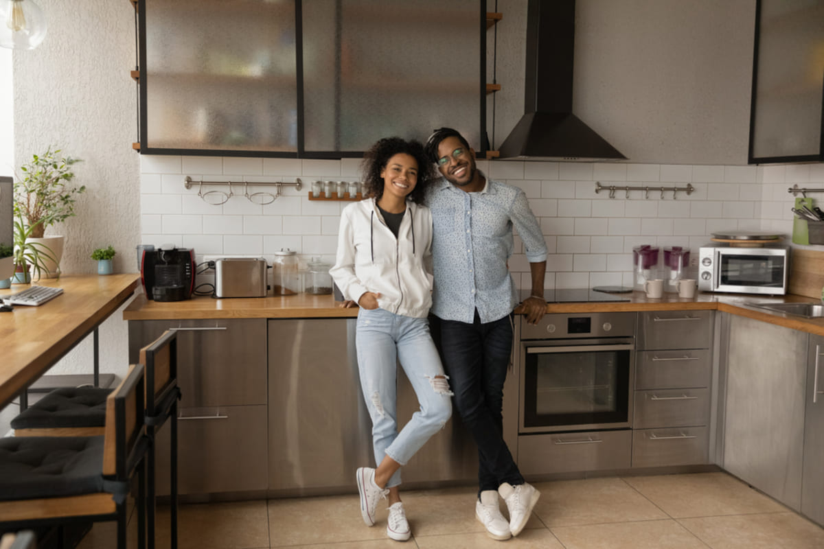 Happy tenants standing in the kitchen