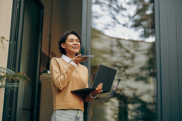 Female property owner holding a laptop on a call with property manager