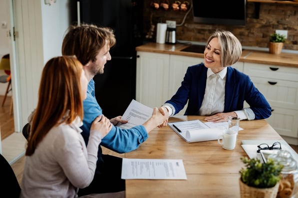 Property manager discusses property management fees with rental property owner couple