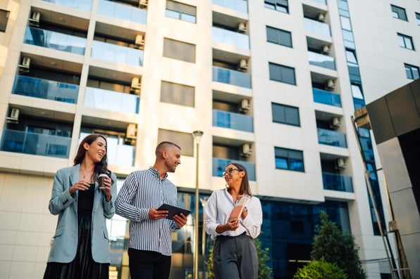 Property management team discusses work outside multifamily building