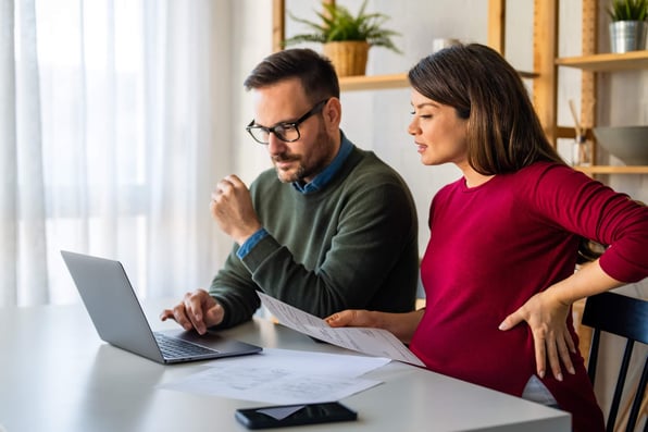 Married landlord couple reviewing rental property maintenance plan together