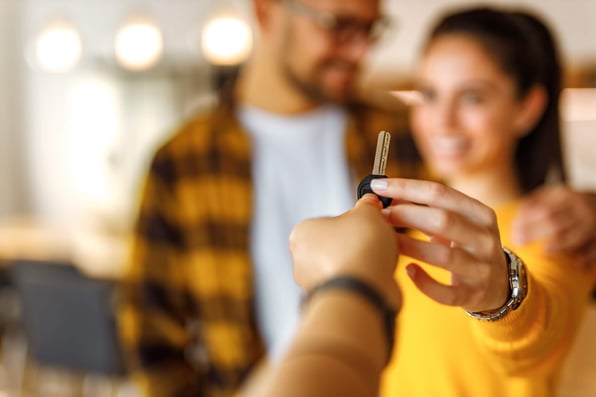 Male and female short term renters get keys to rental property
