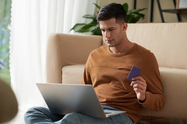 Male tenant using a credit card to prepay rent