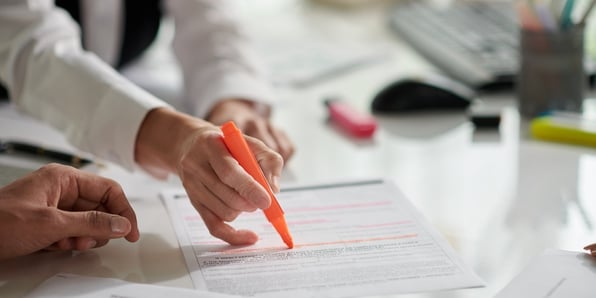 Someone highlighting important details on a document