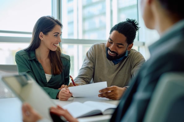Male and female renters sign a rental agreement after passing a tenant screening