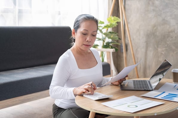 Female rental property owner calculates tenant costs