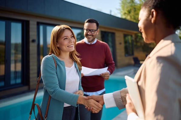 Female tenant shakes hands with Hampton property manager