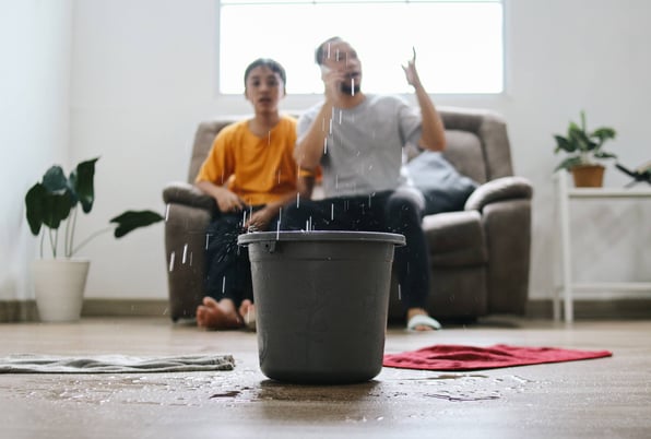 Tenant on the phone with landlord about fixing a roof leak in rental property