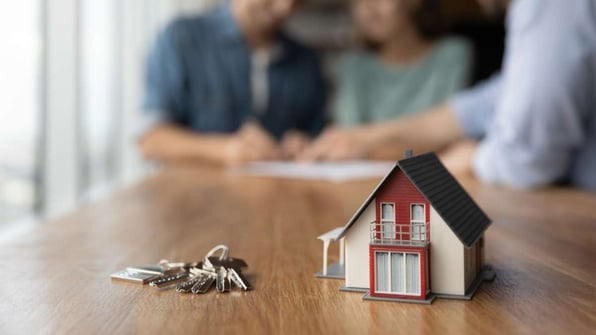 Keys and toy house on the table