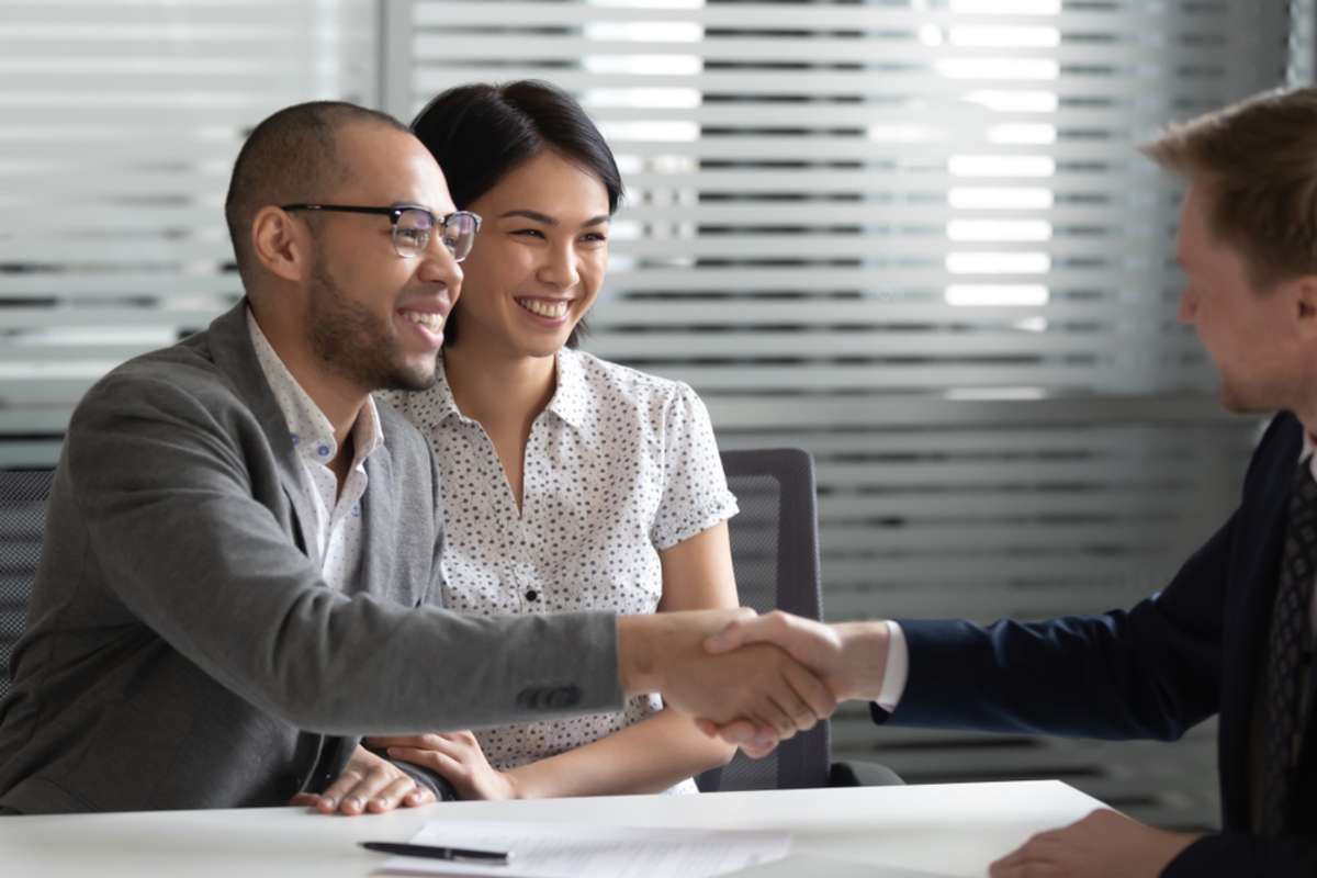 Happy couple shaking hands with property manager, home rental companies concept