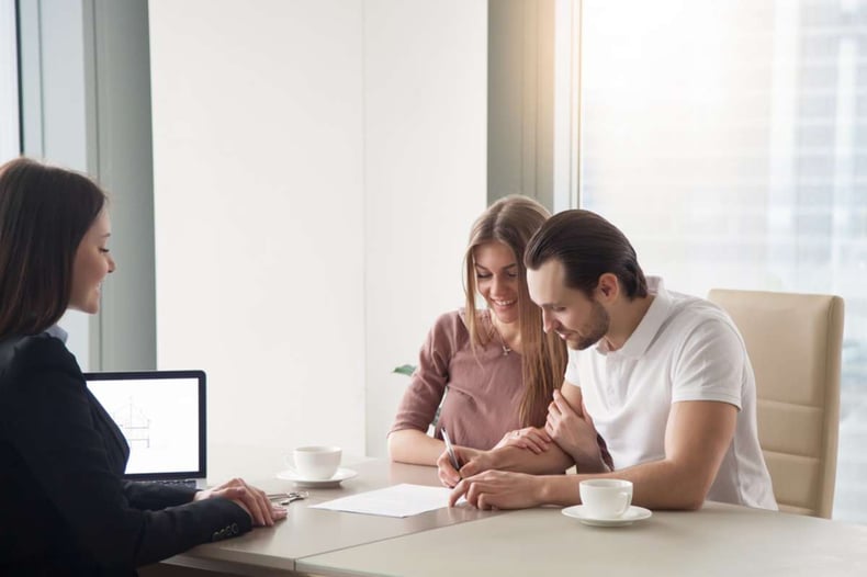 Happy young couple taking real estate purchase loan
