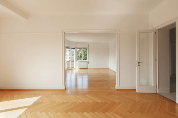 An empty open home with white walls and wood floors