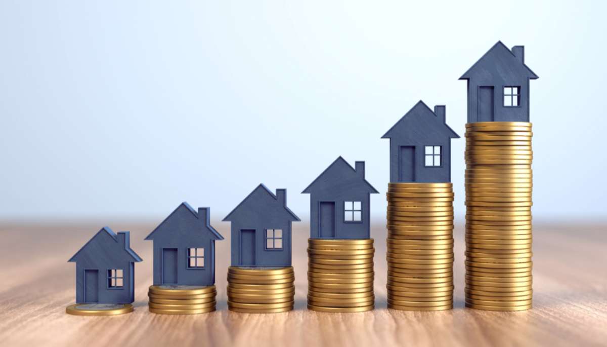 Multiple model houses on growing stacks of coins, portfolio property management concept