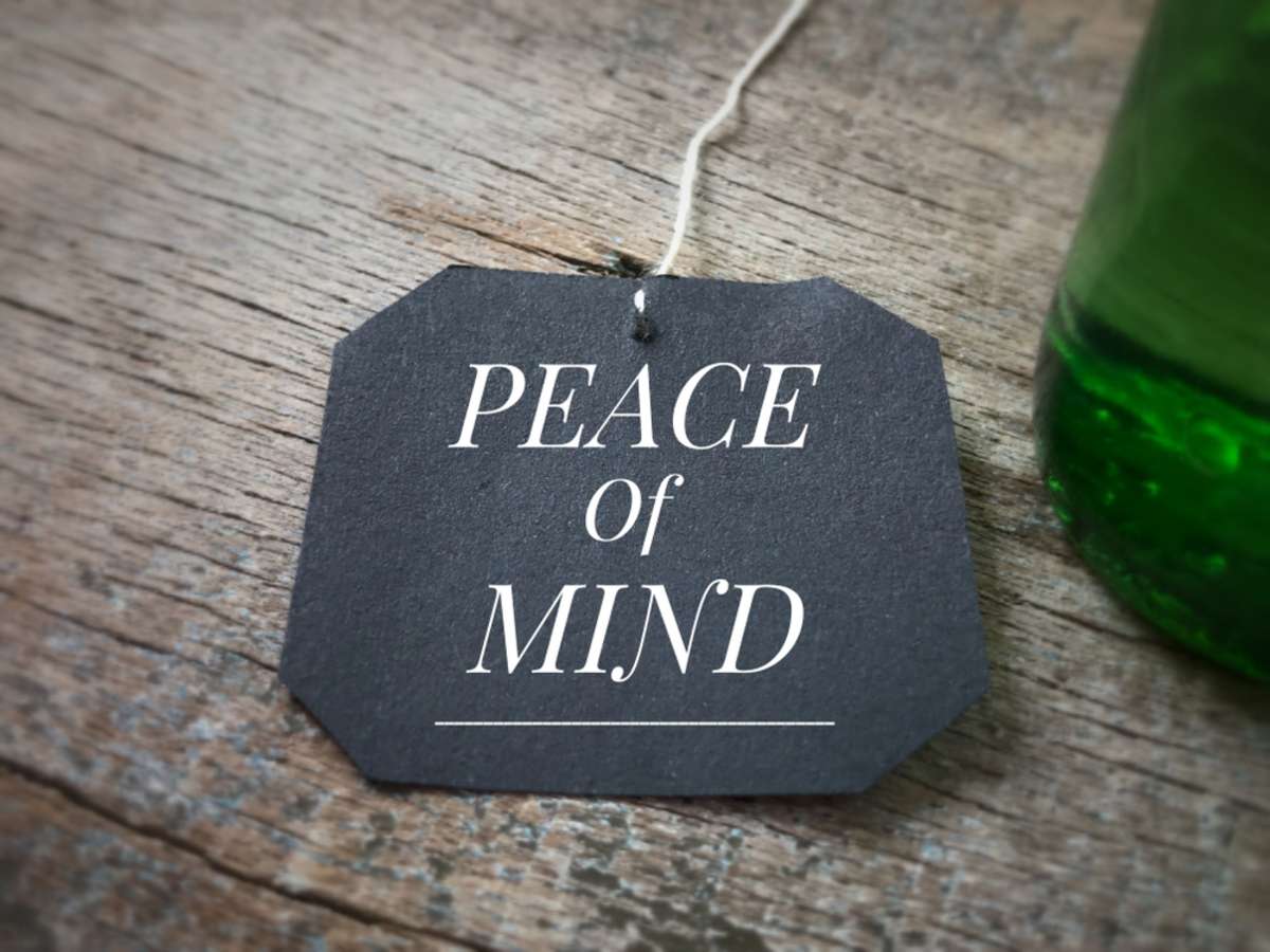 Peace of mind written on a black piece of paper