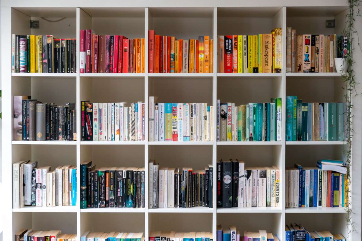 White wooden bookcase filled with books in a UK home setting