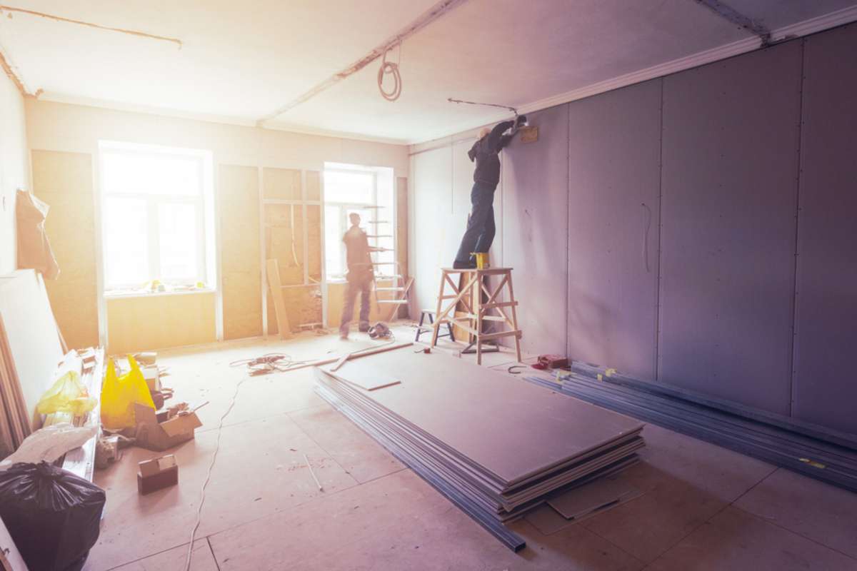 Workers renovating a room, property rental rehab concept
