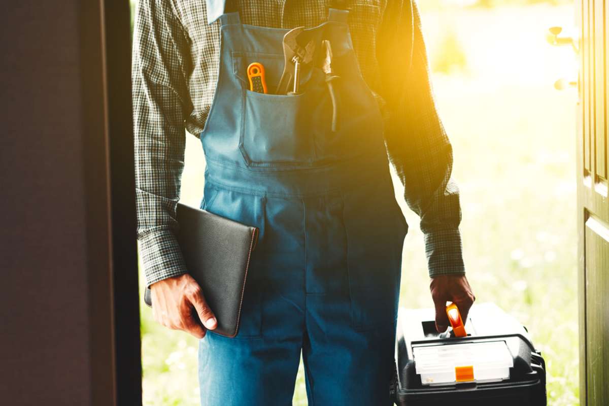 Maintenance worker at the door, rental property maintenance concept.