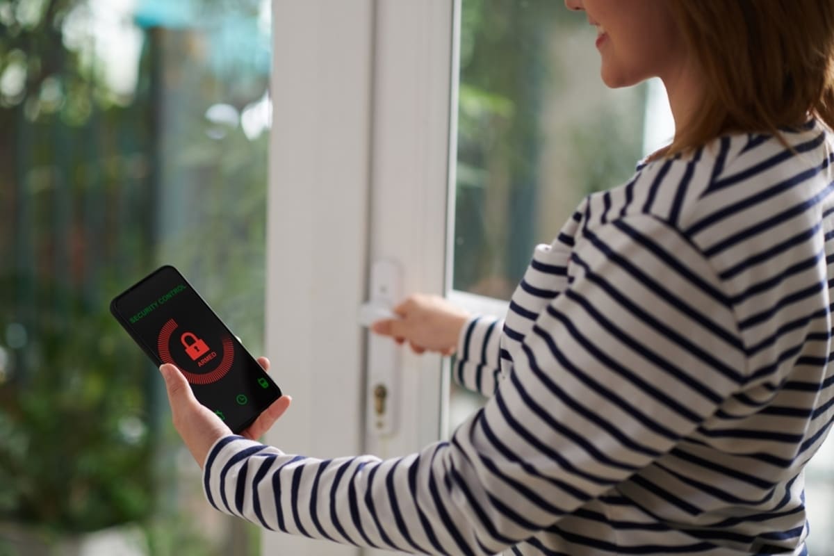 Tenant using a phone to lock smart locks in her rental home