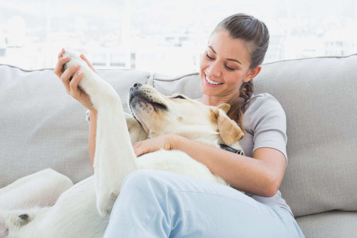 A woman holding her dog in her pet-friendly rental home