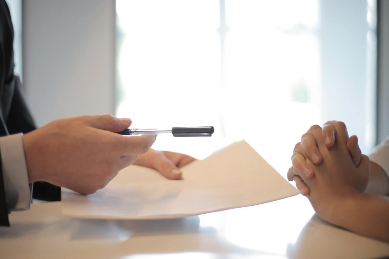 Close-up of documents handed to a person, eviction notice concept. 