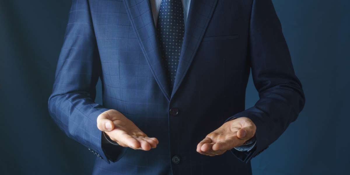 Man in suit holds hands with palms up