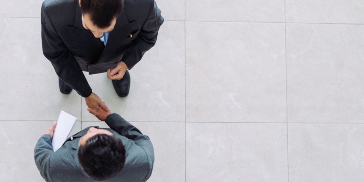 Businessmen shaking hands in a modern office